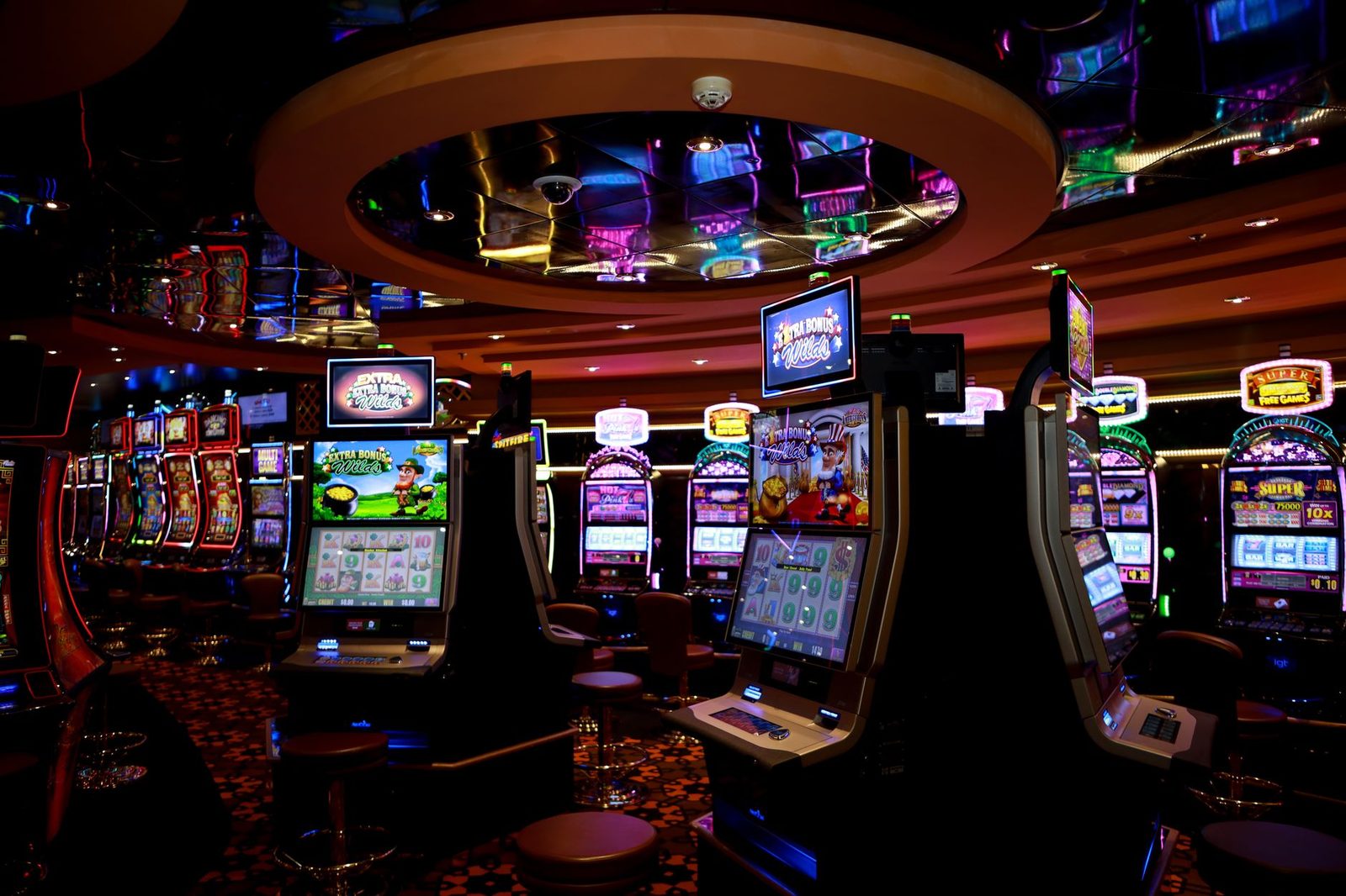 Vibrant casino floor with colorful slot machines and bright lights capturing a lively gaming atmosphere.