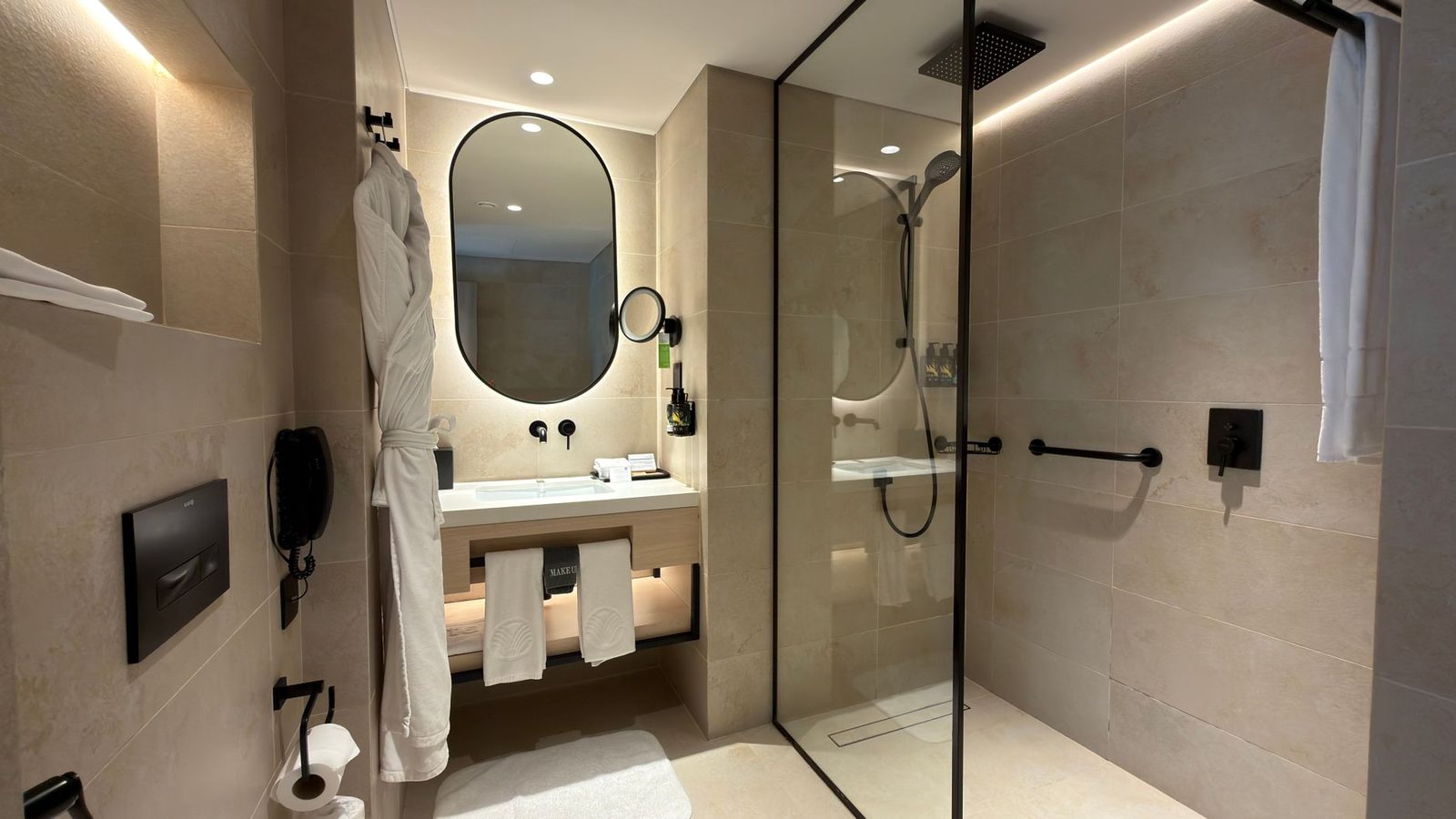 Luxurious hotel bathroom featuring a sleek shower and contemporary fixtures.