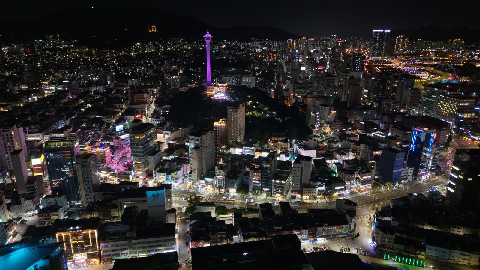 Stunning aerial night view of Busan city, highlighting Busan Tower in South Korea.